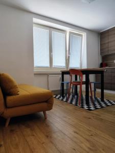 a living room with a table and a couch at Studio11 in Medzilaborce