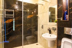 a bathroom with a shower and a sink and a toilet at Entire 3BHK Villa for Families & Groups with Kids Play Area in Jaipur +15 photos