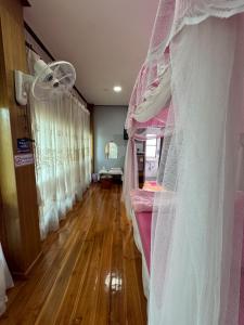 a bedroom with a bed with a veil at น่านสุขโข โฮมสเตย์ in Ban Na Tho
