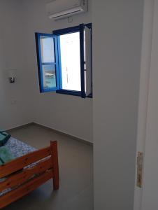 a room with a bench and a window at Central Apartments in Lefkos Karpathou
