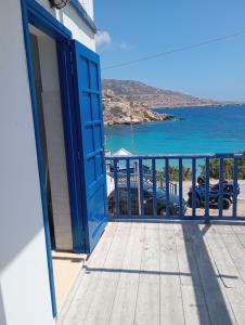 a door to a balcony with a view of the ocean at Central Apartments in Lefkos Karpathou