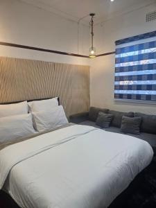 a large white bed in a room with a window at 1krom str bellville boston in Bellville +55 photos