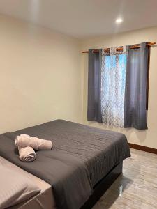 a bedroom with a bed with a towel on it at BalikBalik Villa in El Nido