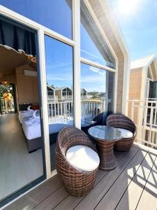 a porch with chairs and a table on a balcony at All Season Resort Semporna in Semporna