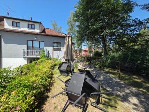 a patio with an umbrella and chairs and a television at Pension Terezka in Frymburk