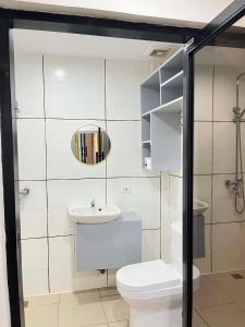 a bathroom with a toilet and a sink and a mirror at BalikBalik Villa in El Nido +16 photos