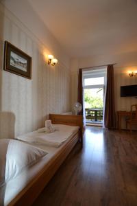 a bedroom with two beds and a large window at Hotel Štekl - Hrubá Skála in Hrubá Skála