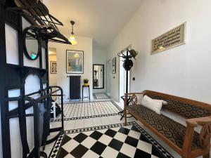 a living room with a couch and a checkered floor at Stadthaus "Villa Moser" nahe Schloss Esterhazy in Eisenstadt
