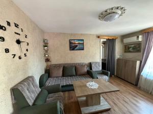 a living room with a couch and a table at Квартира у бульвара 1 in Batumi