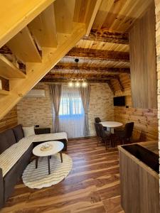 a living room with a couch and a table at Ðedovina mountain cabins in Žabljak