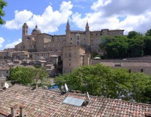 a large building on top of a city with roofs at Blu Arena Hotel in Montecchio