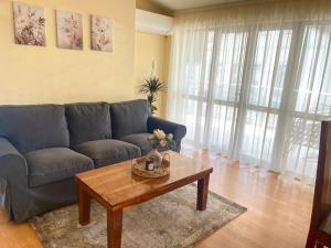 a living room with a couch and a coffee table at Balchik English House in Balchik