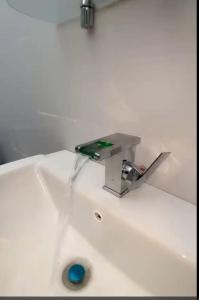 a sink with a faucet on top of it at Mada's House F H L in Abomey-Calavi +22 photos
