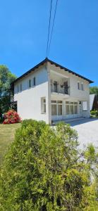 a large white house with a lot of windows at Nadia's home in Ilidža