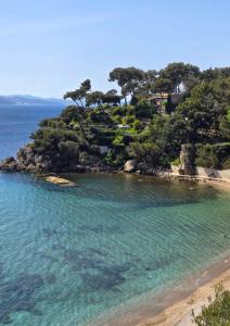 an island with trees on a sandy beach at Un,Deux,Trois...Soleil in Le Pradet