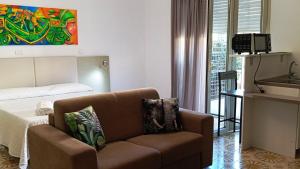 a living room with a couch and a bed at Medoro Camere Milazzo in Milazzo