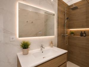 a bathroom with a sink and a mirror at Palazzo Solera Rooms in Casarano