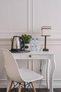 a white desk with a chair and a lamp on it at Zwierzyńscy Residence 2 in Pobierowo