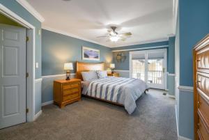 a bedroom with a bed and a ceiling fan at Spacious Resort Villa Near Beach - VBBL in Ocean View