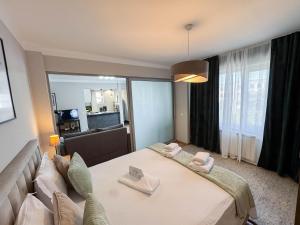 a hotel room with a bed and a couch at Sunrise Apartments City Center in Bucharest