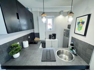 a kitchen with a sink and a counter top at Sunrise Apartments City Center in Bucharest +282 photos