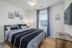 a bedroom with a large bed and a window at Bethany Beach Retreat with Pool - VTC in Frankford