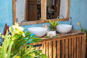 a bathroom with two sinks in front of a mirror at Tunu Beach Zanzibar in Kizimkazi +171 photos