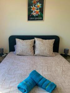 a blanket laying on a bed in a bedroom at La Villa Bleu Lagon in Petite Île