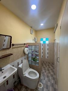 a bathroom with a toilet and a sink at น่านสุขโข โฮมสเตย์ in Ban Na Tho +75 photos