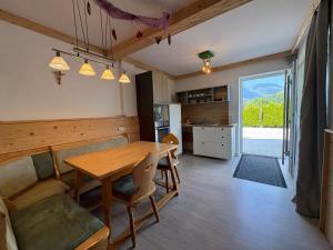 a kitchen and dining room with a wooden table at Ferienwohnung Heissl in Fieberbrunn