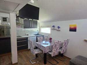 a kitchen and dining room with a table and chairs at Spa Cottage Lavender in Terme Čatež in Čatež ob Savi