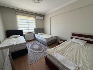 a small room with two beds and a window at Korkmaz Rezidans in Kayseri