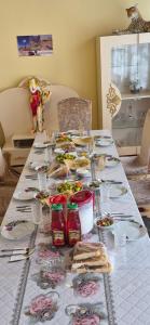 a long table with plates of food on it at Khinalig Shaiq Guest House in Xınalıq
