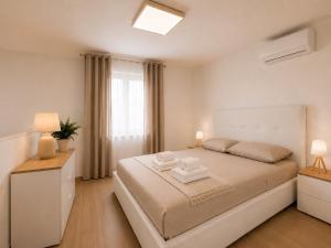 a bedroom with a bed with two towels on it at Palazzo Solera Rooms in Casarano