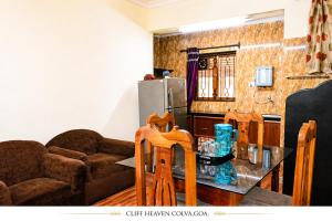 a living room with a couch and a table at Cliff Heaven in Colva