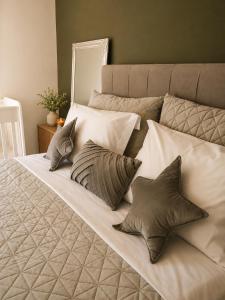 a large bed with four pillows on it at Phos & Kipos Villa in Koskinou +26 photos