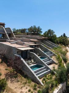 a building with a pool in the middle of a field at KHAI Syvota in Syvota