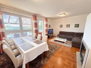 a living room with a table and a couch at Casa Maika in Frymburk