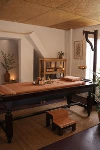 a large bed in a room with a table at Lakshmi Ayurveda Retreat in Kovalam