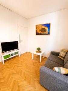 a living room with a couch and a flat screen tv at Apartments Marko in Vodice