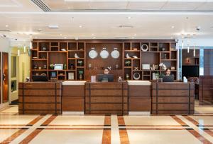 a lobby of a hotel with two people sitting at computers at Majestic Premier Hotel Burdubai in Dubai +60 photos