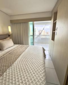 a hotel room with a bed and a balcony at Beach Class Exclusive in Fortaleza +61 photos