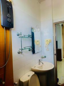 a bathroom with a toilet and a sink at Lafala Hotel & Service Apartment in Colombo +72 photos