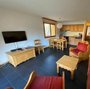 a living room with a couch and a tv at River Dream in Val-d'Illiez