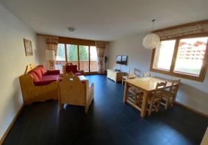 a living room with a couch and a table at River Dream in Val-d'Illiez