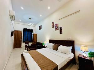 a bedroom with a large bed in a room at Hotel Oxygen Stay in Noida