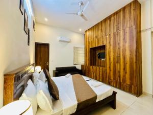 a hotel room with a bed and a television at Hotel Oxygen Stay in Noida +48 photos