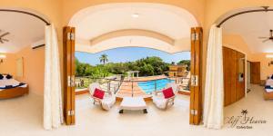 a room with a balcony with a table and chairs at Cliff Heaven in Colva