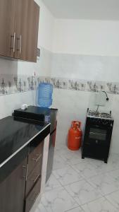 a kitchen with a sink and a stove in it at Hermit Homes in Mombasa