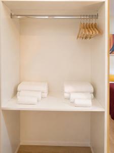 a closet with white towels on a shelf at Relais Principe Umberto in Naples